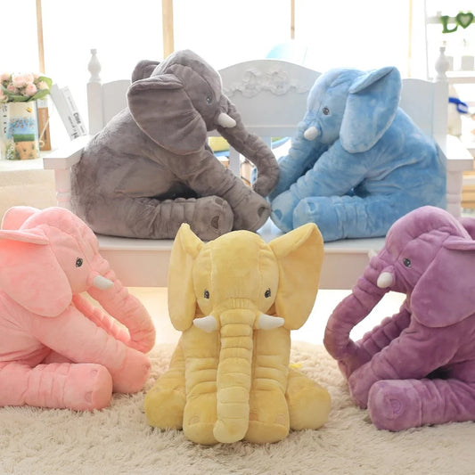 Soft plush elephant toy with a long nose in pink, purple, blue, yellow & grey, perfect for babies. This cute, huggable design doubles as a pillow or lumbar cushion. Available in two sizes.